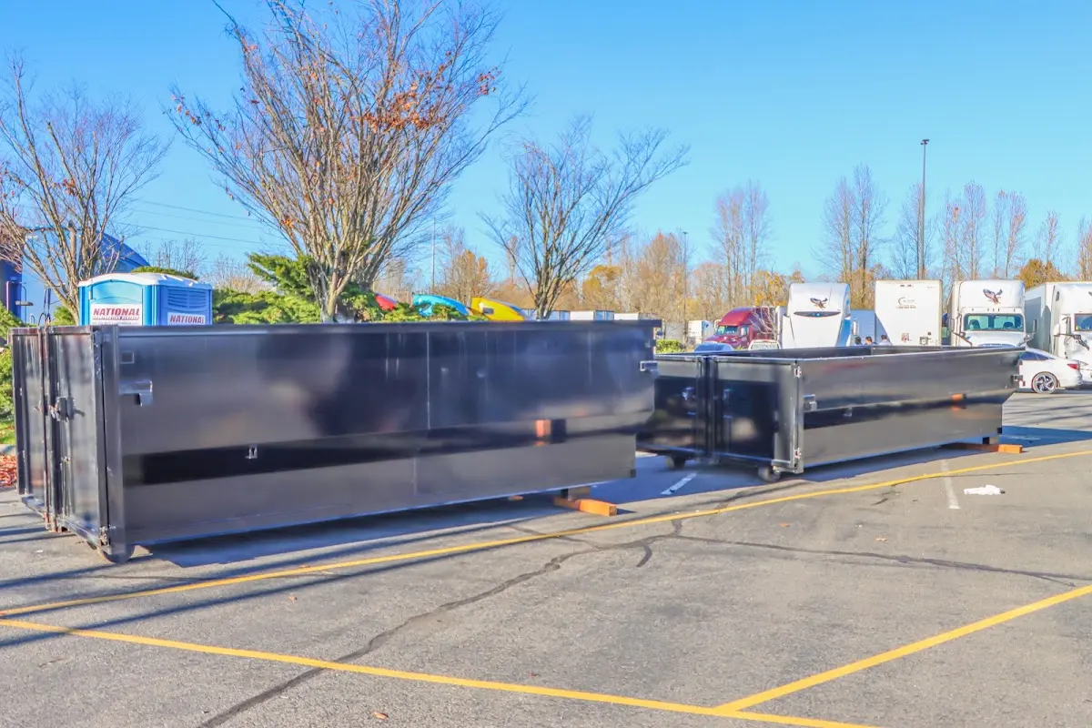 Professional dumpster rental service with roll-off container on residential driveway in Blue Ash